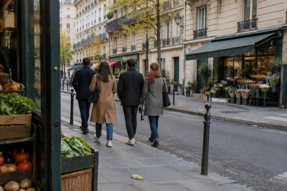 Guided food tour group walking along a Paris market street